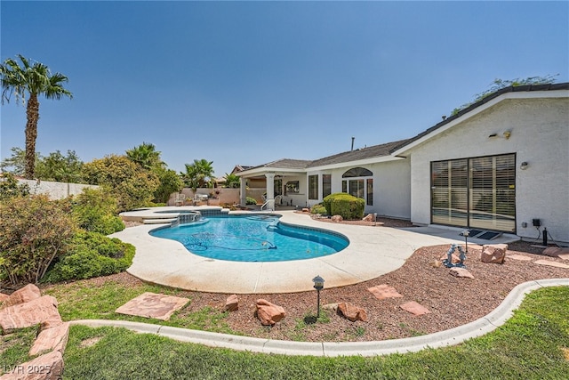 view of pool with a patio area and an in ground hot tub