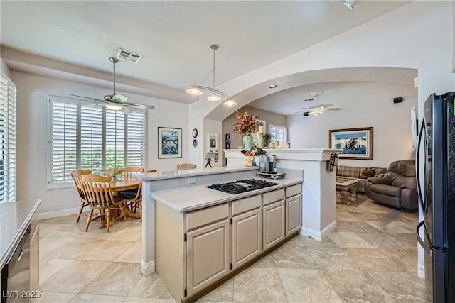 kitchen featuring ceiling fan, hanging light fixtures, a textured ceiling, and appliances with stainless steel finishes