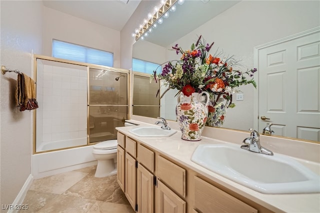 full bathroom with shower / bath combination with glass door, vanity, and toilet