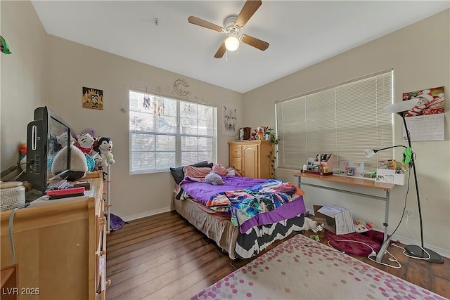 bedroom with dark hardwood / wood-style floors and ceiling fan