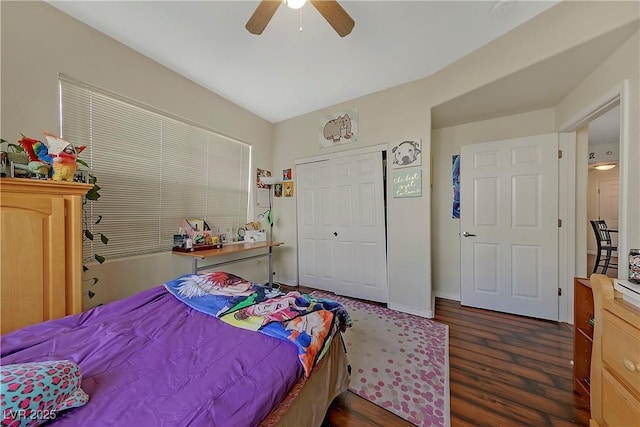 bedroom with ceiling fan, dark wood-type flooring, and a closet