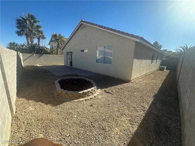 view of side of home featuring central AC and a patio area