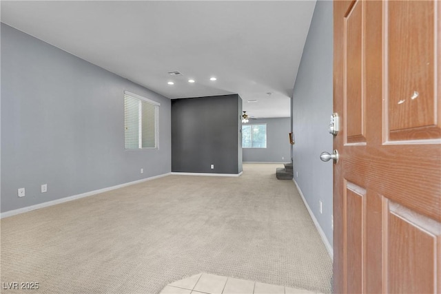 unfurnished room featuring light carpet and ceiling fan