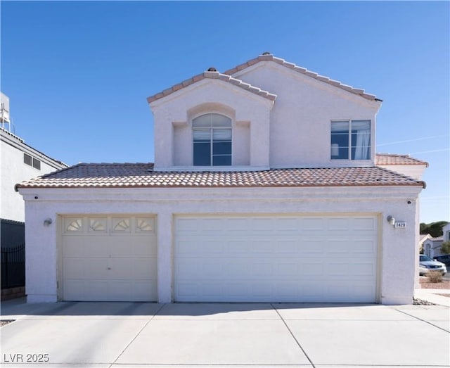 mediterranean / spanish-style home with a garage