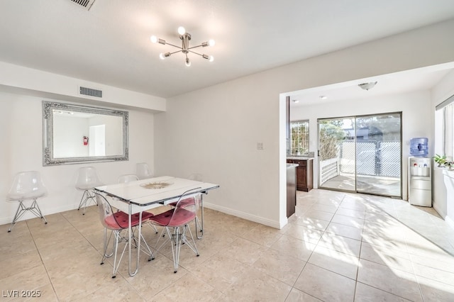 dining area featuring light tile patterned floors and a chandelier