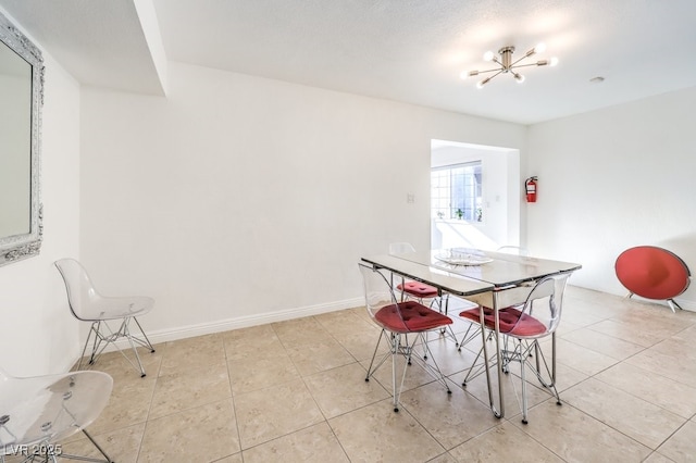 tiled dining area with a chandelier