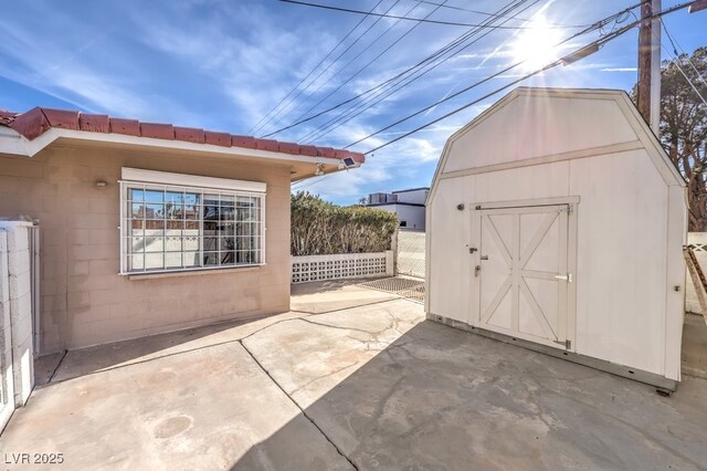 view of patio featuring a shed