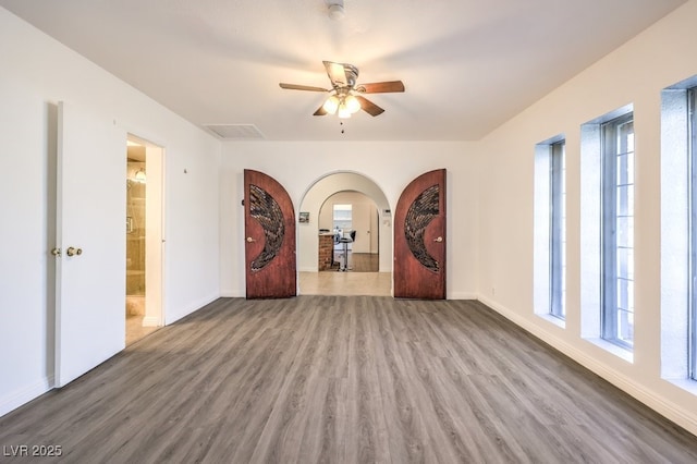 empty room with hardwood / wood-style flooring and ceiling fan