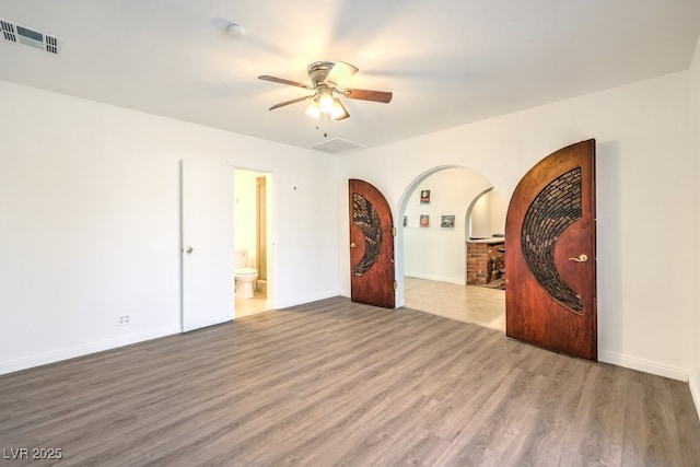 empty room featuring ceiling fan and hardwood / wood-style flooring