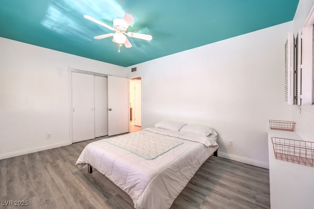 bedroom featuring hardwood / wood-style floors, a closet, and ceiling fan