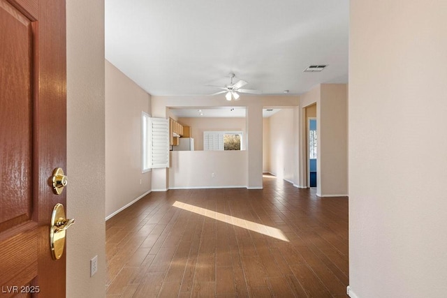 unfurnished room featuring ceiling fan and dark hardwood / wood-style floors