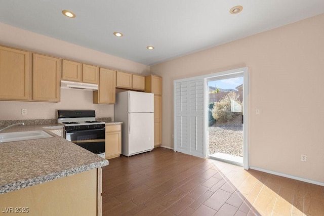 kitchen with hardwood / wood-style flooring, sink, light brown cabinets, and white appliances