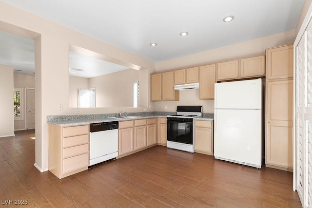 kitchen with sink, a healthy amount of sunlight, light brown cabinets, and white appliances