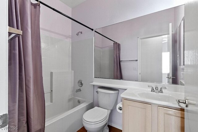 full bathroom featuring toilet, vanity, and shower / bathtub combination with curtain