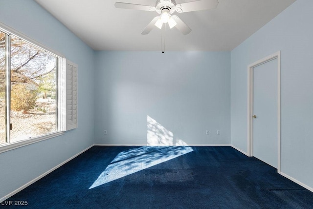 carpeted empty room featuring ceiling fan