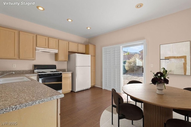 kitchen featuring dark hardwood / wood-style flooring, sink, light brown cabinetry, and white appliances