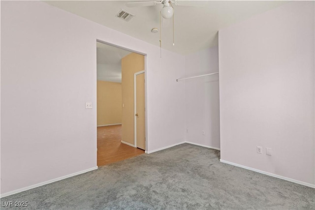 carpeted spare room featuring ceiling fan