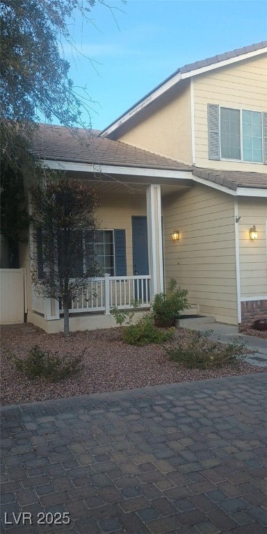 back of house featuring a porch