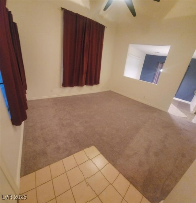 carpeted spare room with ceiling fan