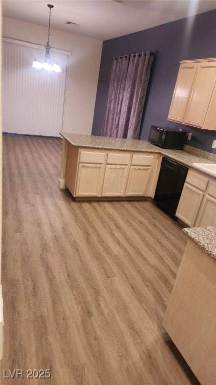 kitchen featuring black appliances, sink, hanging light fixtures, light wood-type flooring, and a notable chandelier