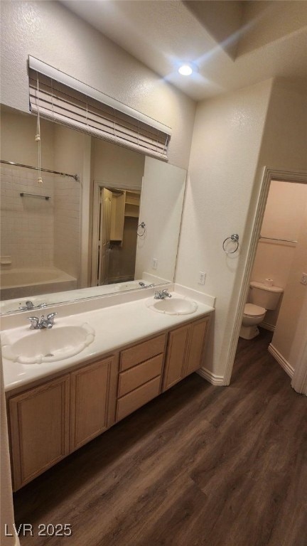 bathroom with vanity, wood-type flooring, and toilet