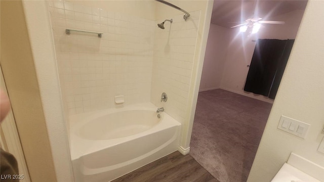 bathroom featuring tiled shower / bath combo, hardwood / wood-style flooring, and ceiling fan