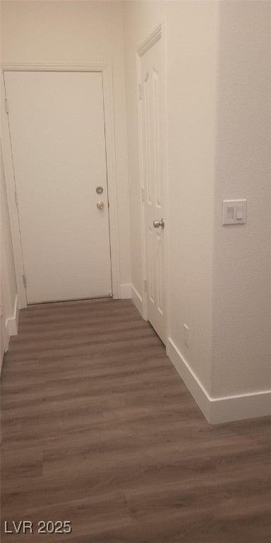 hallway with dark wood-type flooring