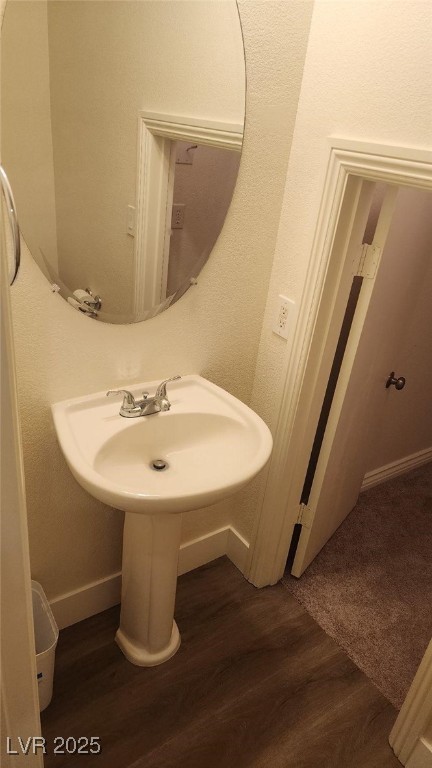 bathroom with hardwood / wood-style floors