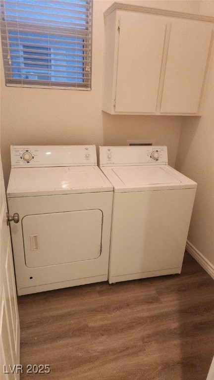 laundry area featuring cabinets, independent washer and dryer, and dark wood-type flooring