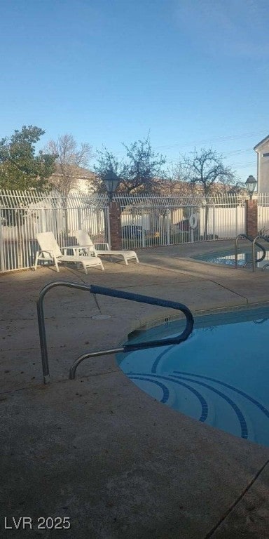 view of swimming pool with a patio