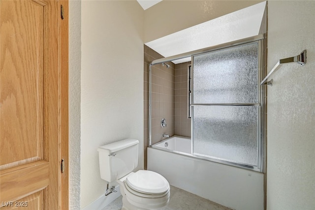 bathroom featuring toilet and combined bath / shower with glass door