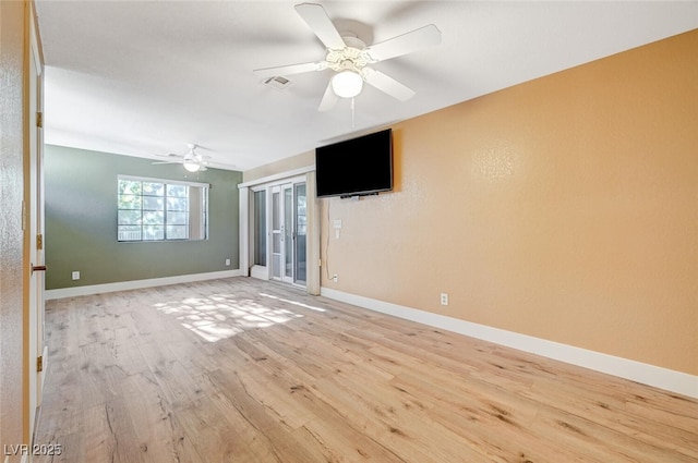 spare room featuring ceiling fan and light hardwood / wood-style floors