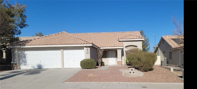 view of front of house featuring a garage and central air condition unit