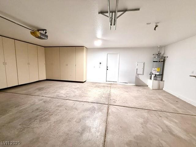 garage featuring strapped water heater and a garage door opener