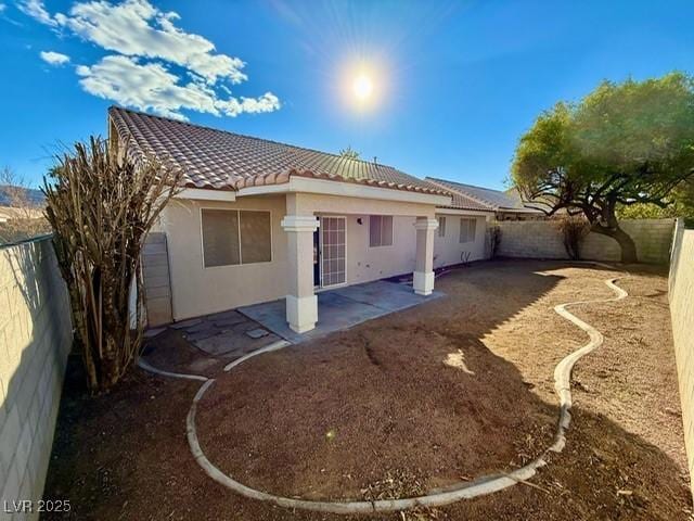 back of house with a patio