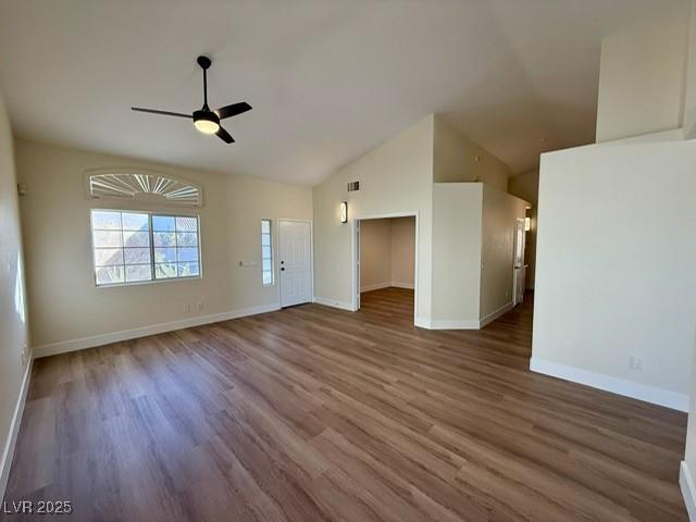 unfurnished living room featuring ceiling fan, dark hardwood / wood-style flooring, and lofted ceiling