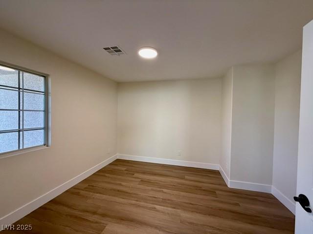 empty room featuring wood-type flooring