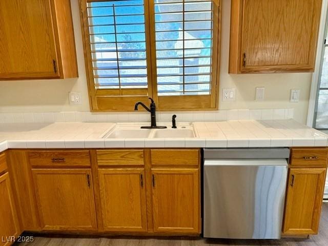 kitchen featuring dishwasher, tile countertops, and sink