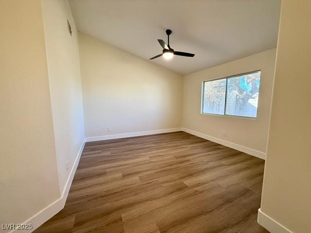 spare room with hardwood / wood-style floors and ceiling fan