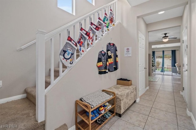 interior space featuring tile patterned flooring and ceiling fan