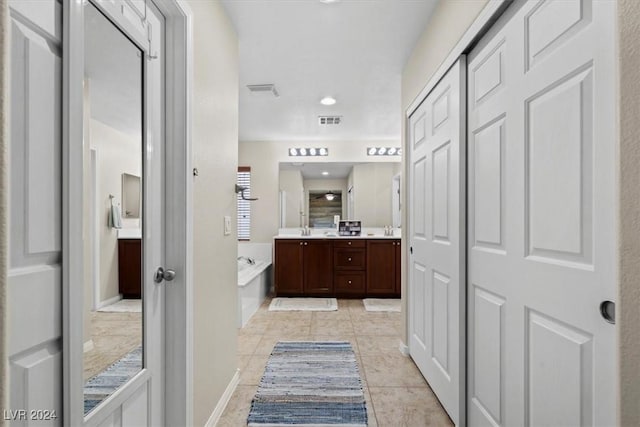 bathroom featuring tile patterned flooring, vanity, and separate shower and tub