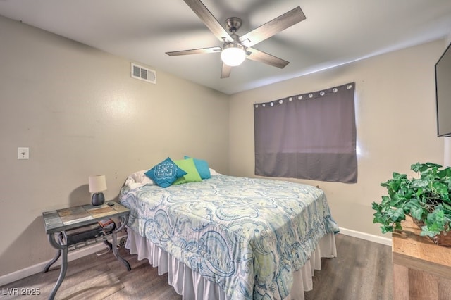 bedroom with dark hardwood / wood-style flooring and ceiling fan