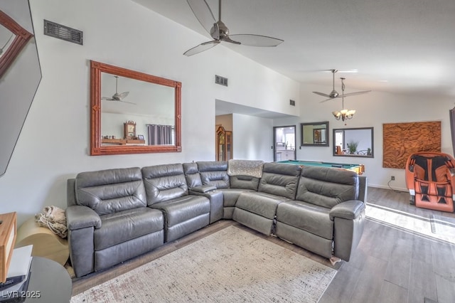 living room featuring lofted ceiling and hardwood / wood-style floors