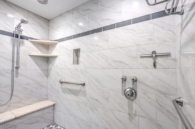 bathroom with a tile shower