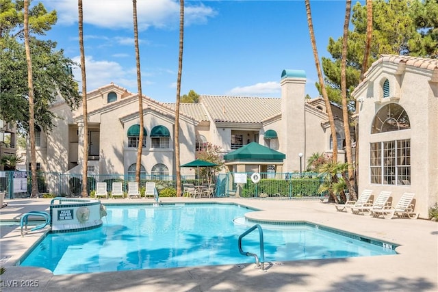 view of swimming pool featuring a patio area and a community hot tub