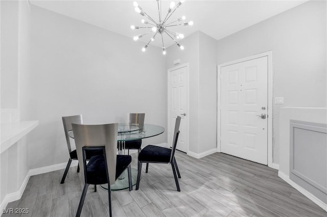 dining room featuring an inviting chandelier and light hardwood / wood-style flooring