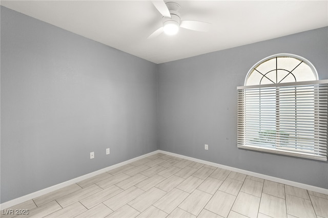 empty room featuring a wealth of natural light and ceiling fan