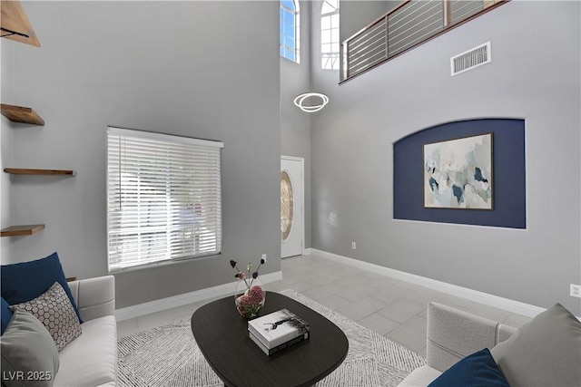 living room with a high ceiling and a wealth of natural light