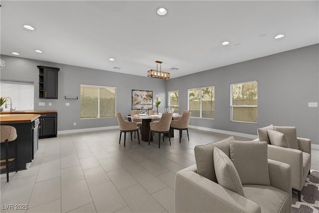 dining room featuring a chandelier and sink