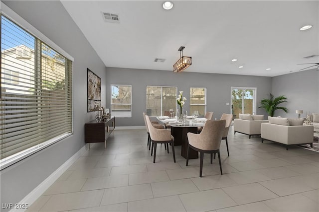 dining space with a wealth of natural light and ceiling fan